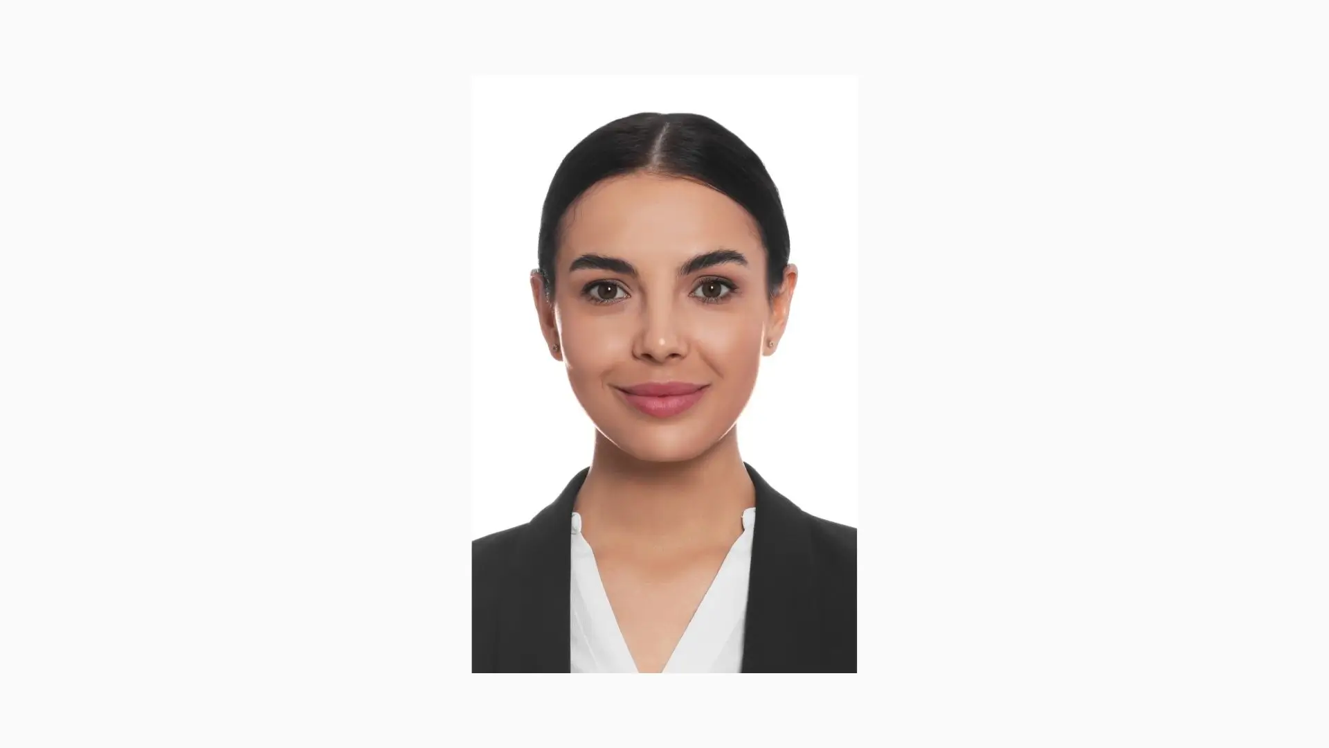 A professional woman in a business suit stands confidently against a clean white background.