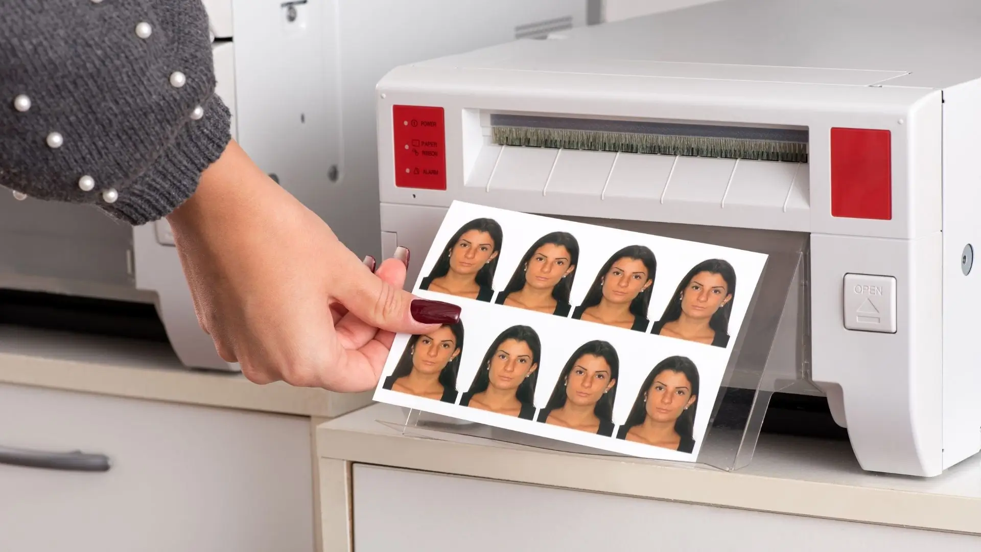 A person operates a printer, producing vibrant pictures from a computer or device.