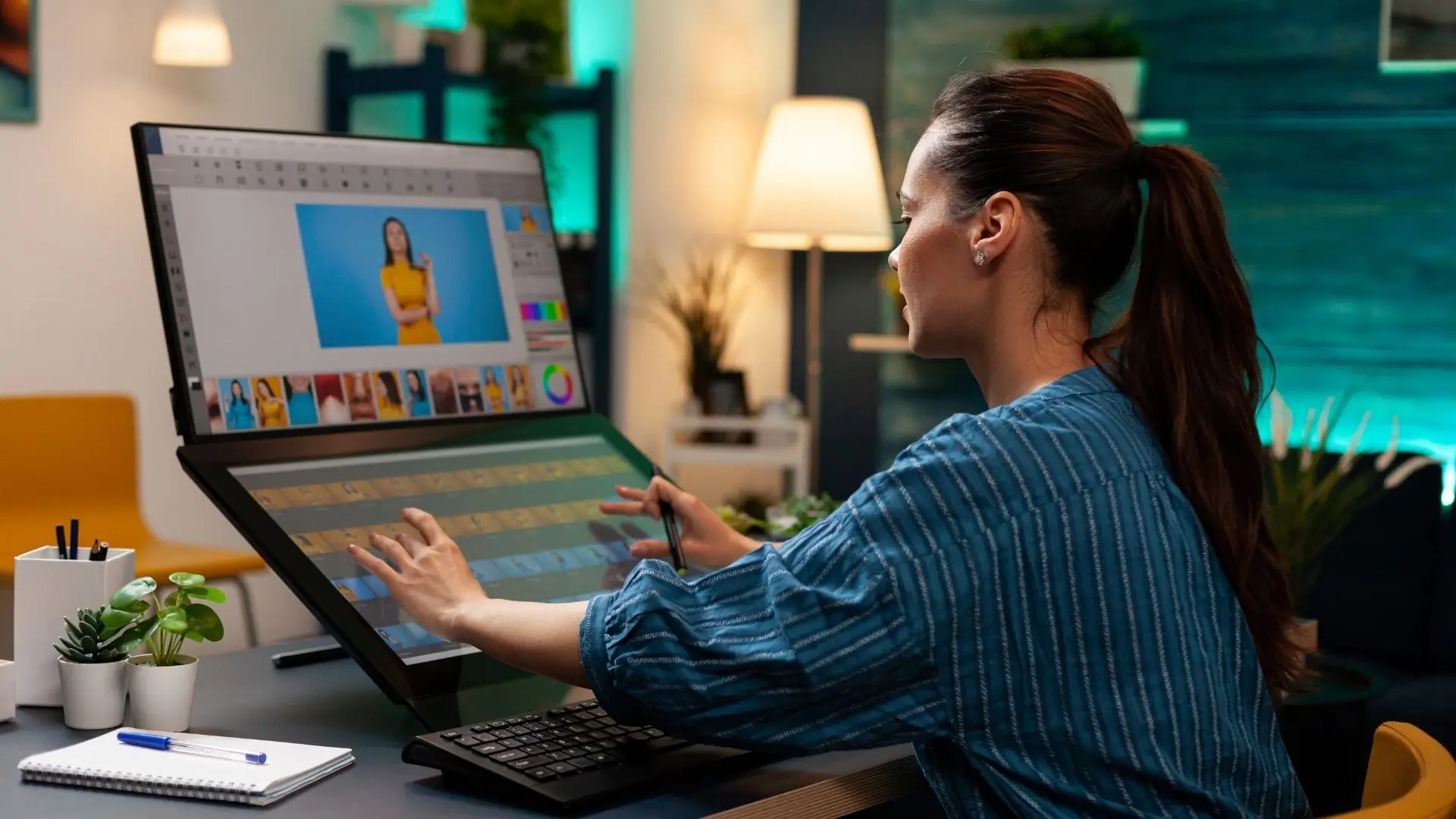 A woman interacts with a touch screen computer, focused on her work and engaged with the technology.