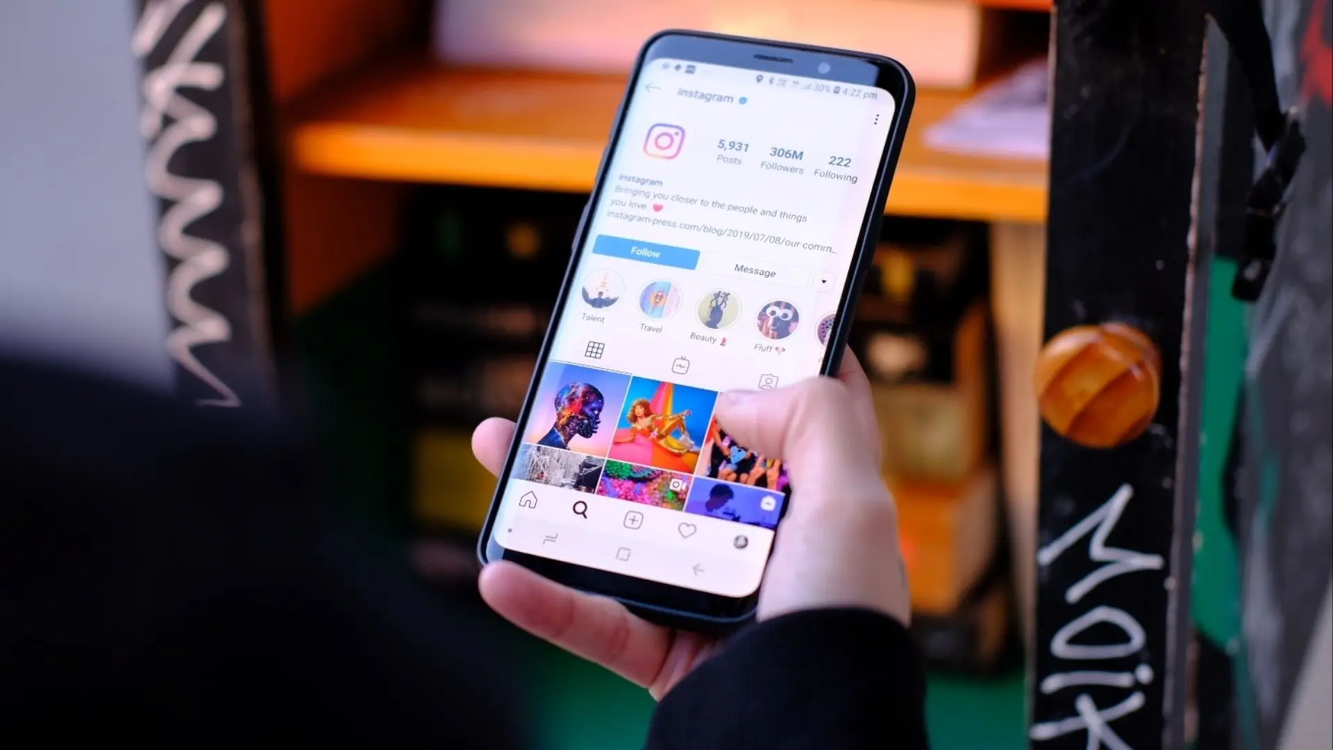 A person holding a smartphone displaying the Instagram app on the screen, showcasing social media engagement.