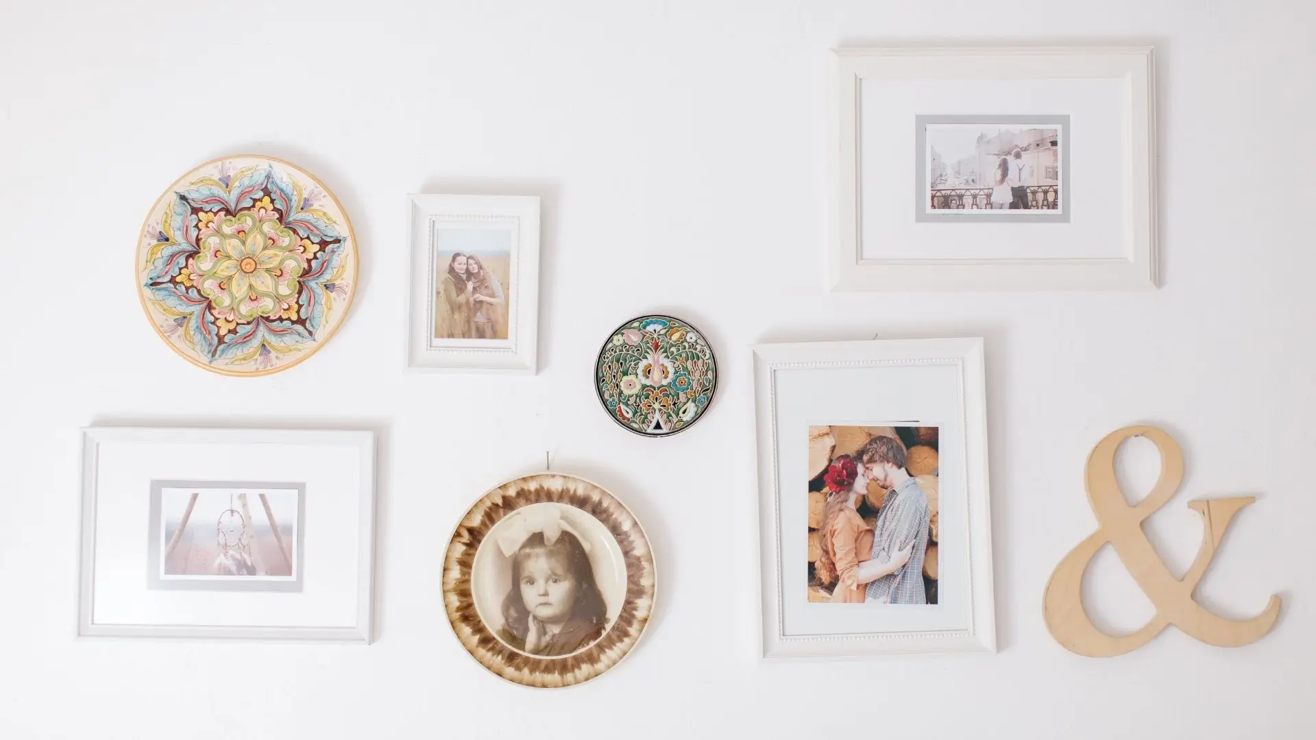 A wall adorned with various pictures and letters, creating a vibrant and personal display of memories and messages.
