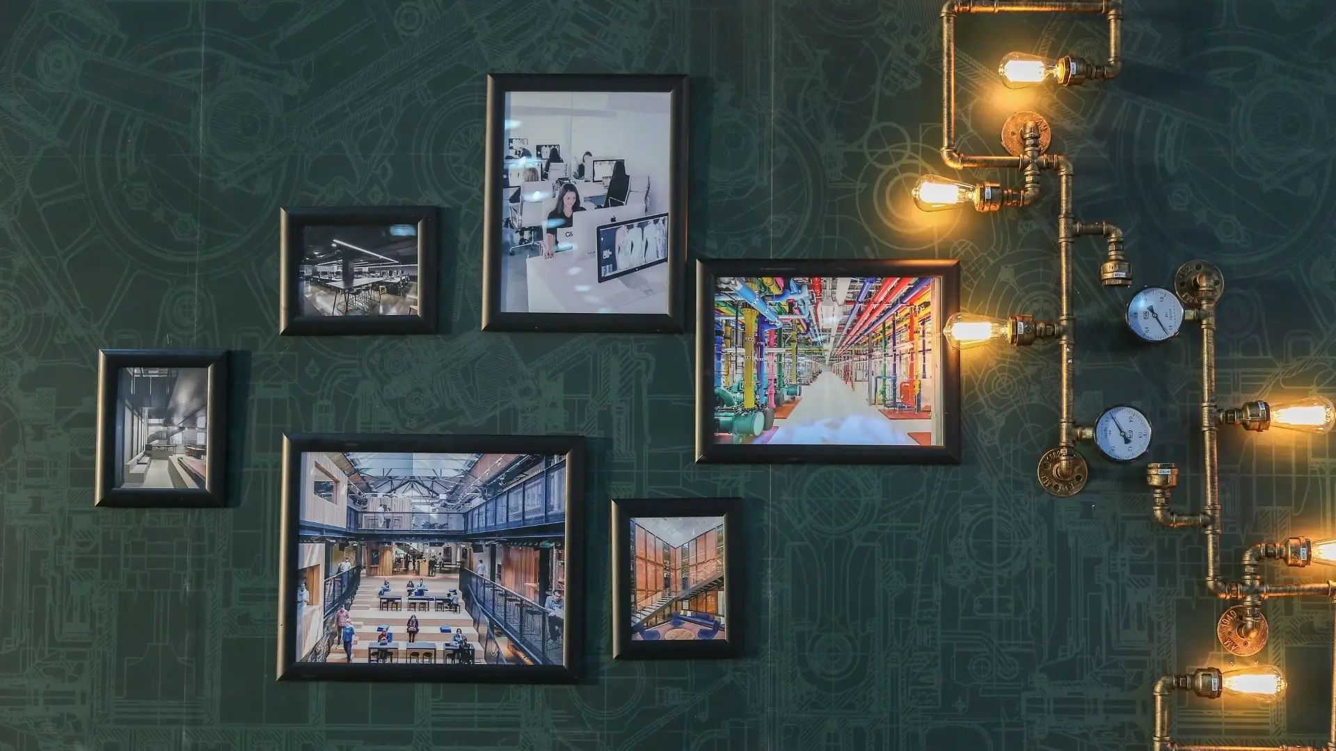 A wall adorned with various pictures and illuminated by decorative lights, creating a warm and inviting atmosphere.