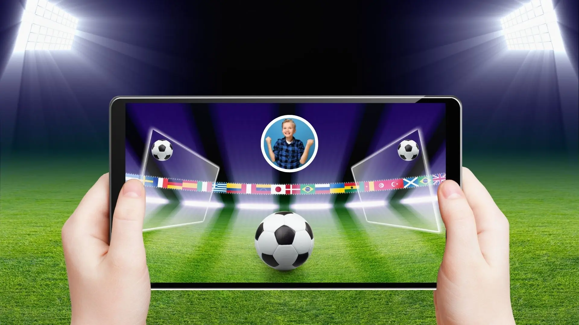 A person stands on a soccer field, holding a tablet while a soccer ball rests nearby on the grass.