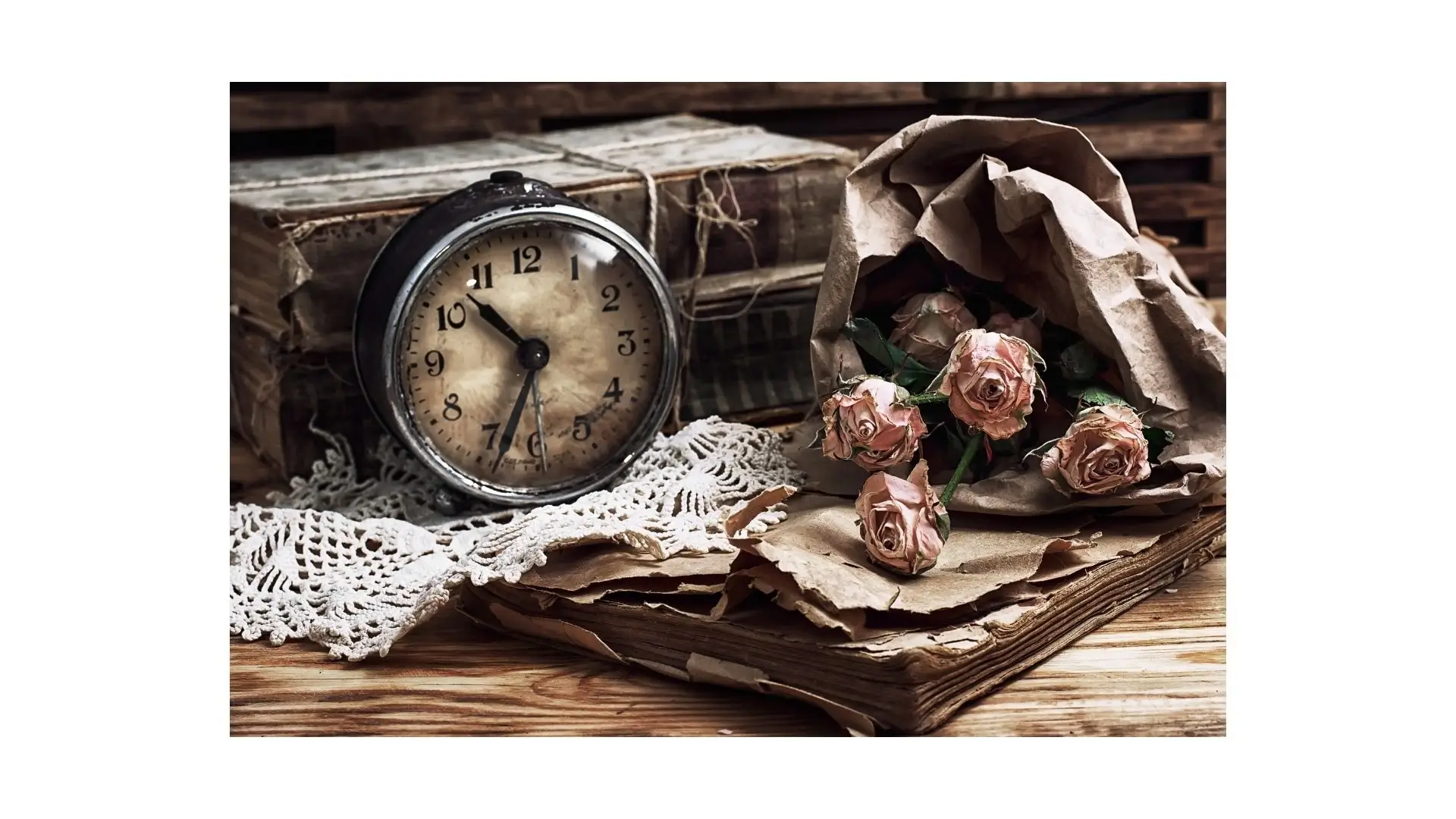 A decorative clock surrounded by vibrant roses on a wooden table, creating a charming and elegant atmosphere.