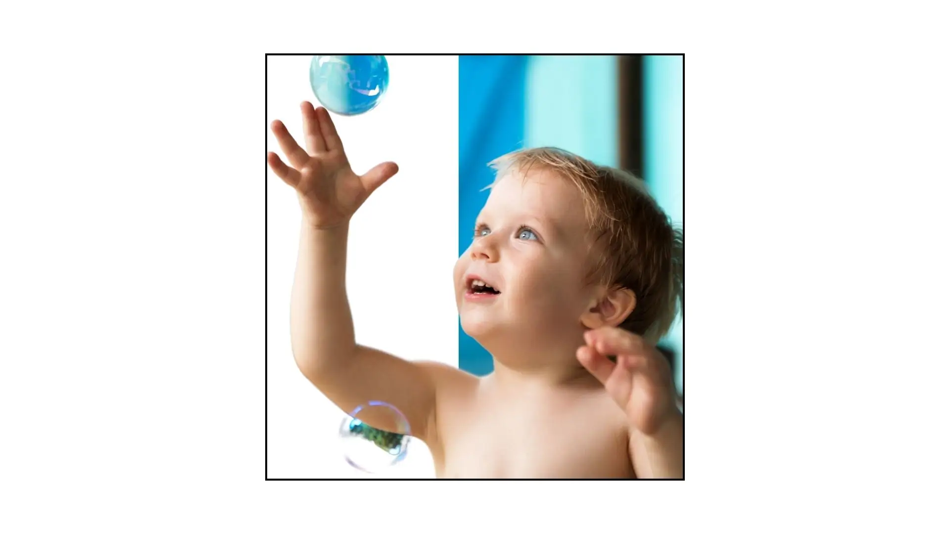 A baby joyfully plays with bubbles, illuminated by sunlight streaming through a window.