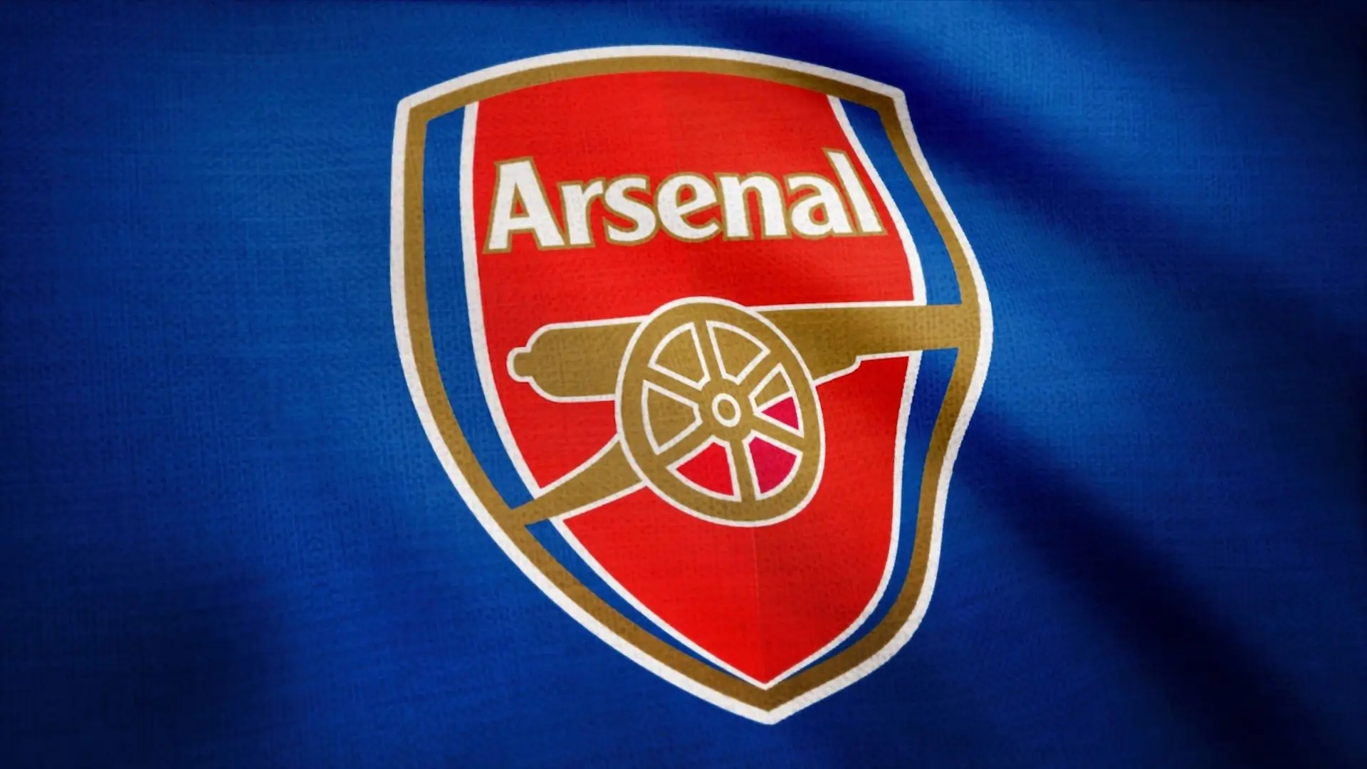 Arsenal logo displayed prominently on a blue shirt, showcasing team pride and vibrant color contrast.