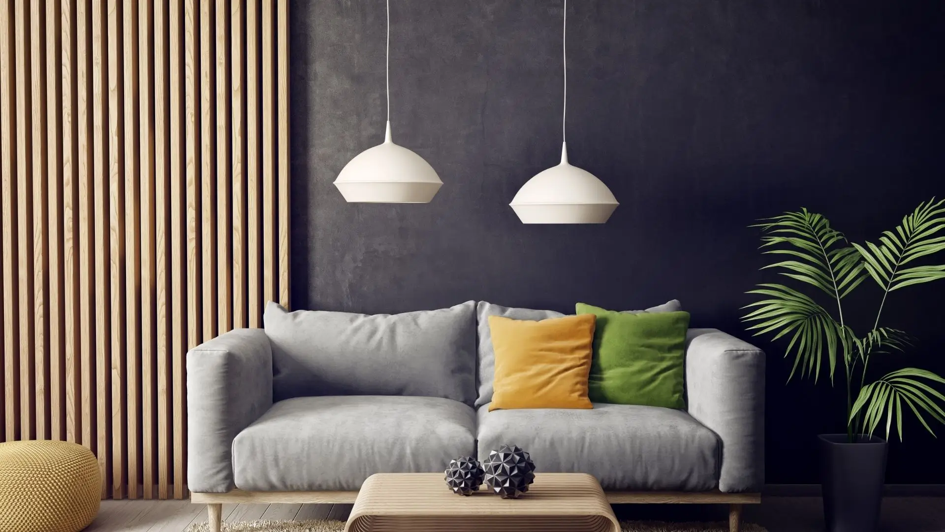 A contemporary living room featuring a stylish couch, a coffee table, and two elegant pendant lights overhead.‍