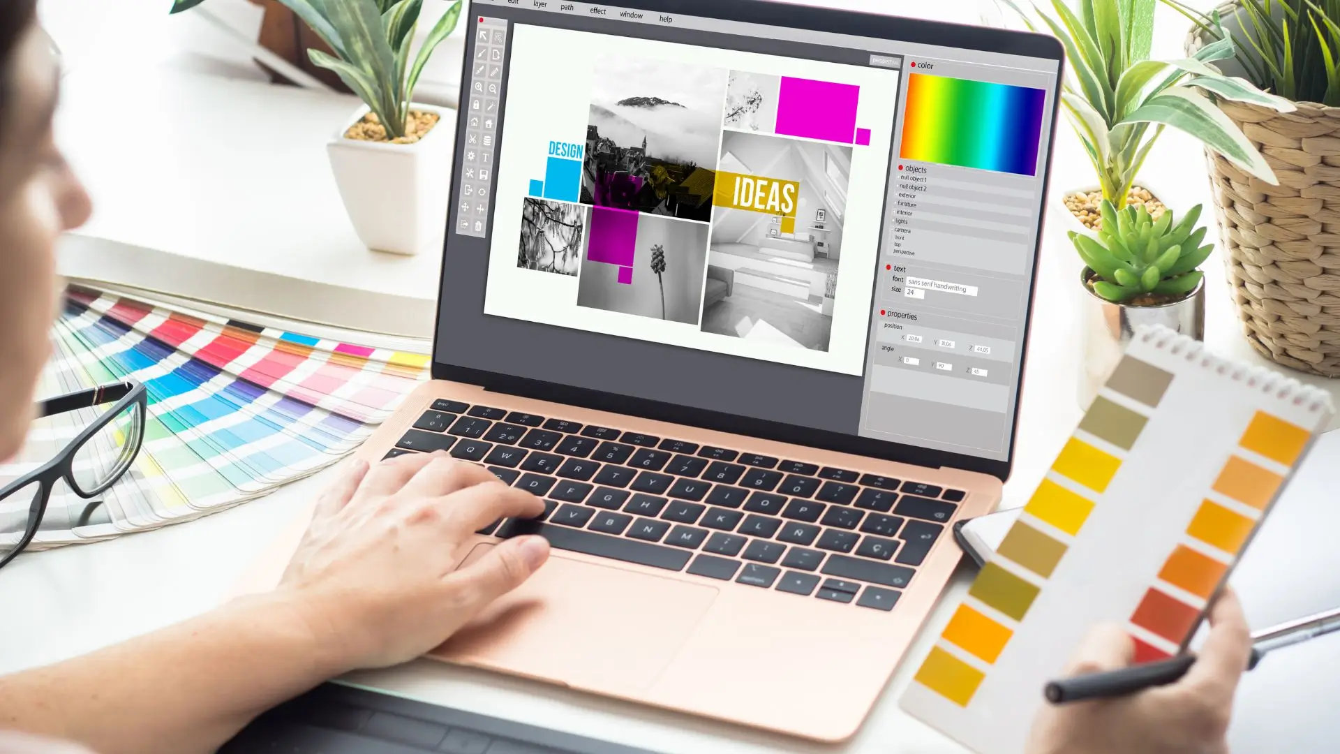 A person focused on a laptop, surrounded by vibrant colors on the screen, showcasing creativity and productivity.