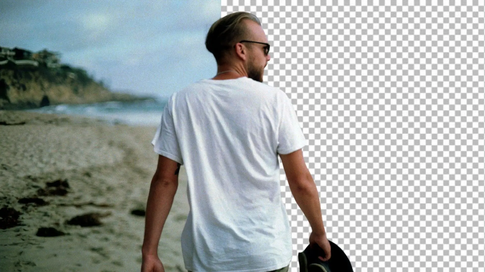 A man wearing a hat strolls along the beach, enjoying the sun and the sound of the waves.