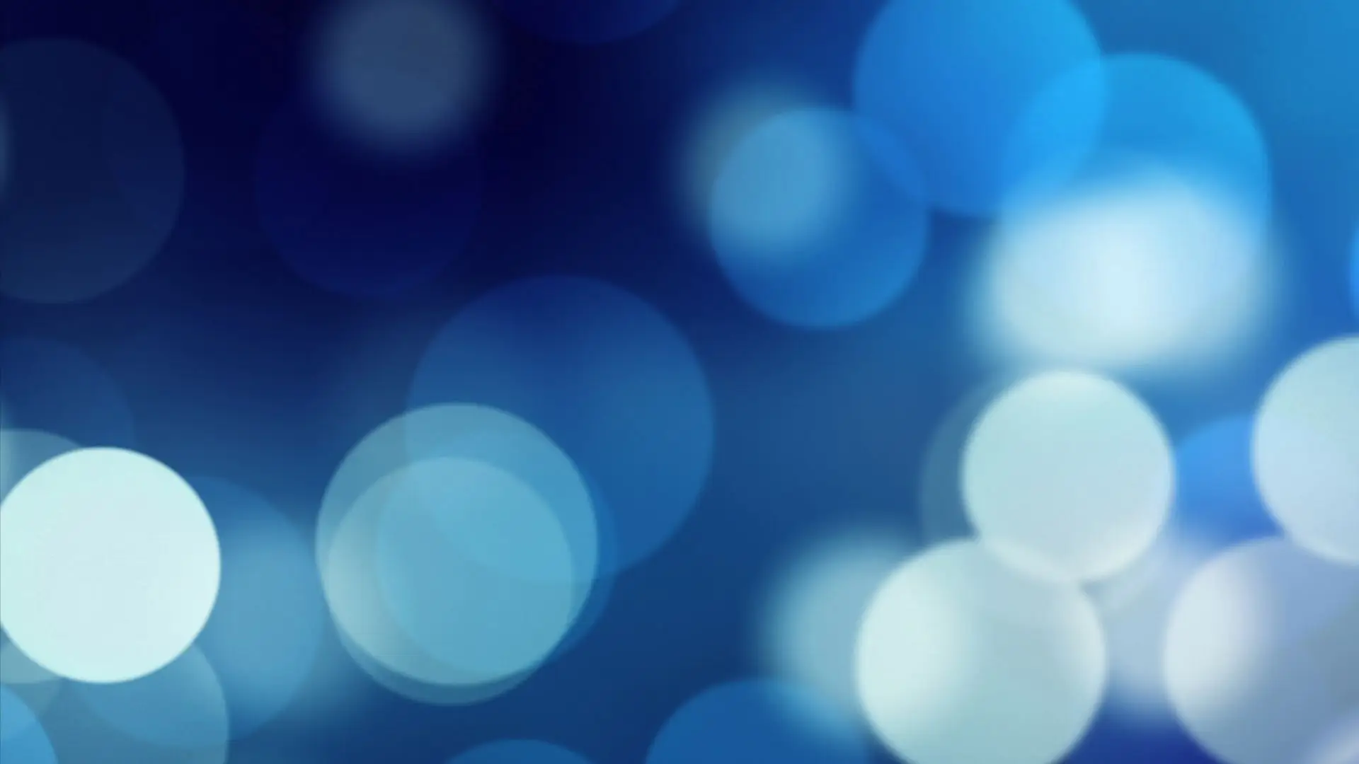 A blue bokeh background featuring softly blurred lights, creating a dreamy and tranquil atmosphere.