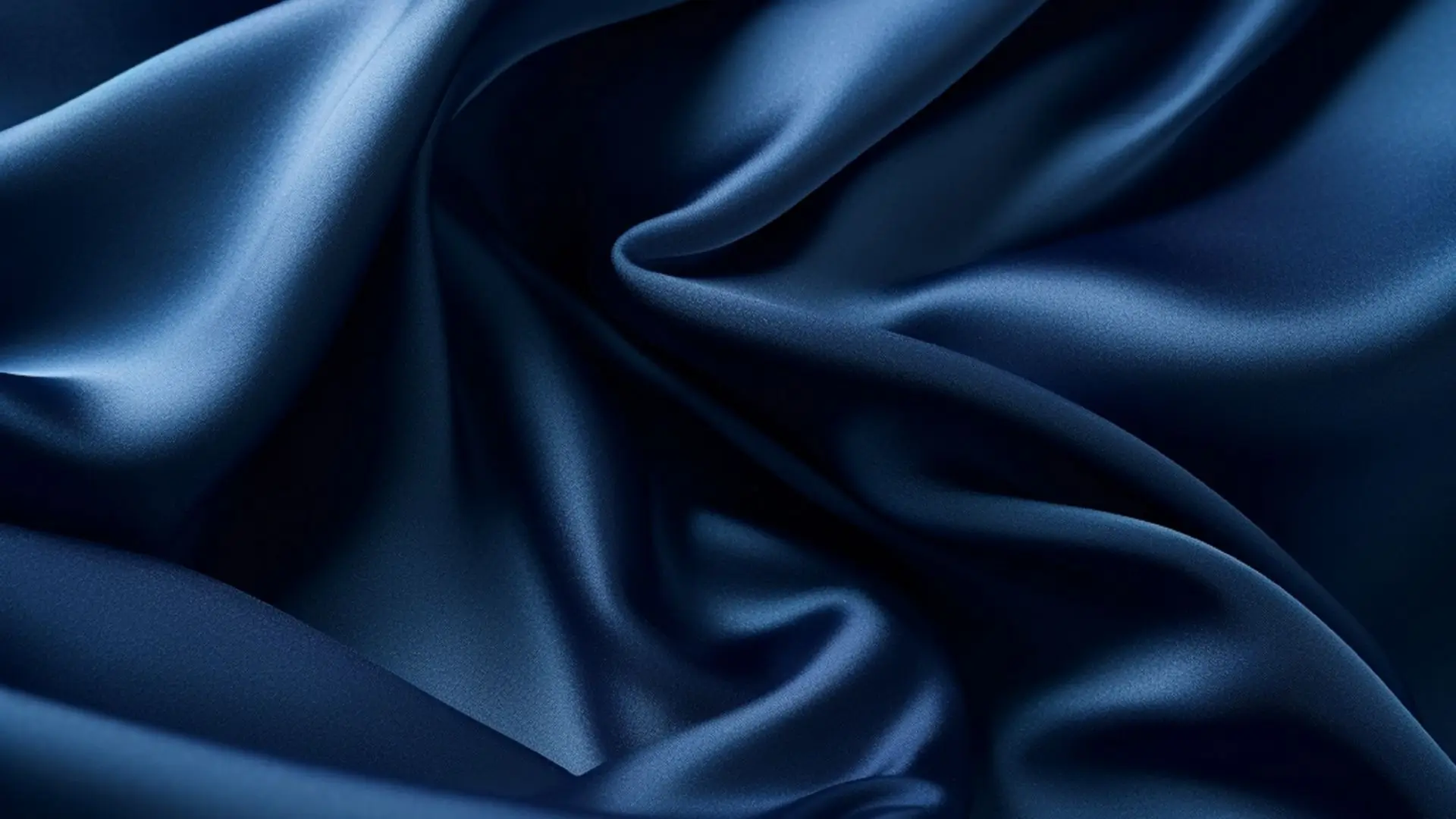 Close-up of luxurious blue satin fabric, showcasing its smooth texture and rich color.