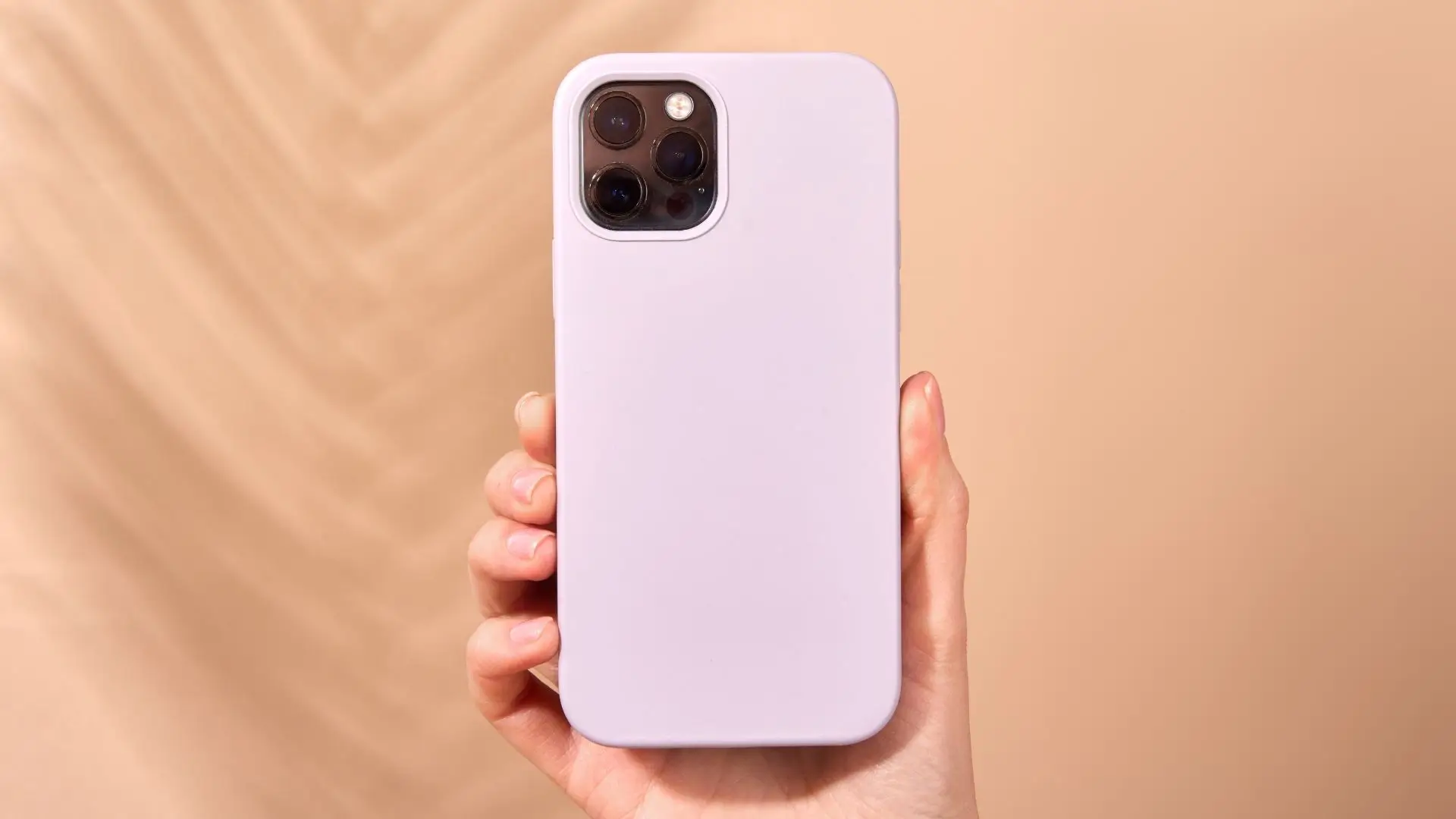 A person displaying a purple iPhone case, showcasing its vibrant color and sleek design in their hand.