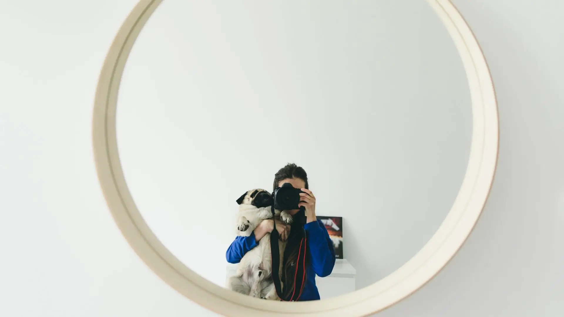 A person capturing a selfie in a mirror, showcasing their reflection and surroundings.‍