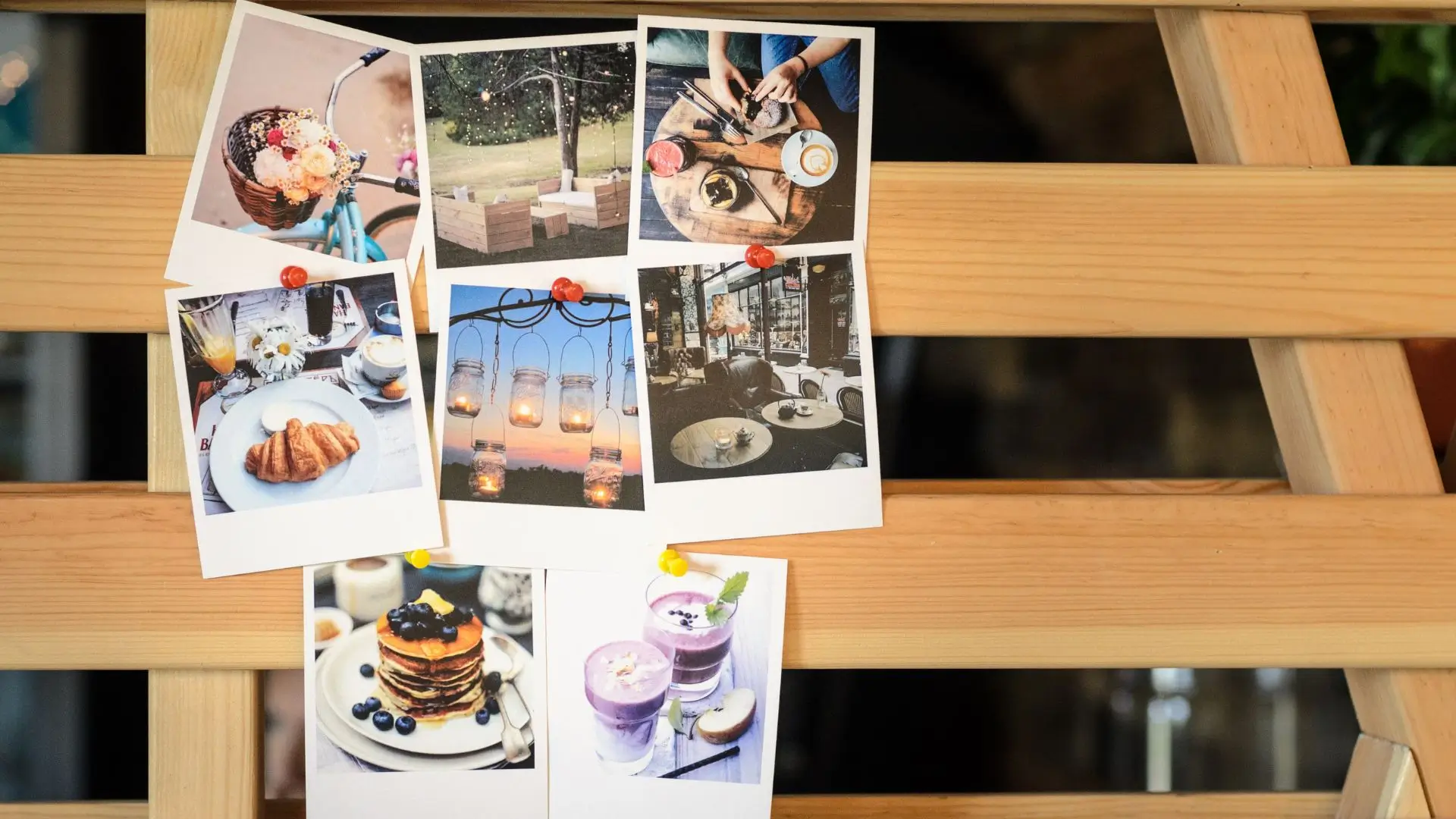 A wooden table displaying an array of food and drink pictures, showcasing a variety of culinary delights.